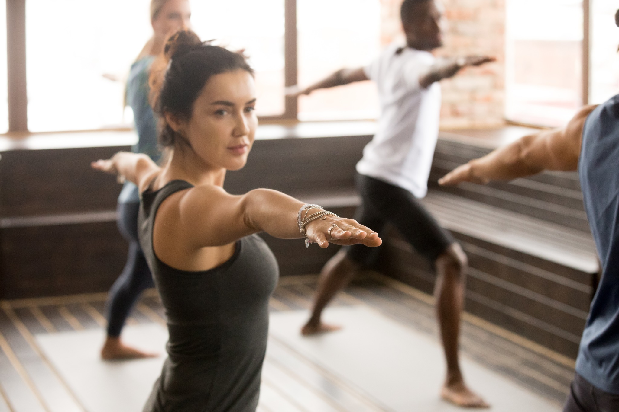 Photo of woman in a class to try yoga for the first time.